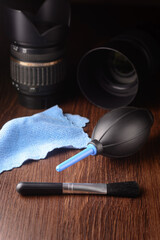 lens cleaning kit with dslr lenses, on a dark background, camera cleaning concept