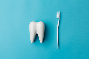 The concept of dental health and dental care. Dentist's day. A white toothbrush lies next to a...