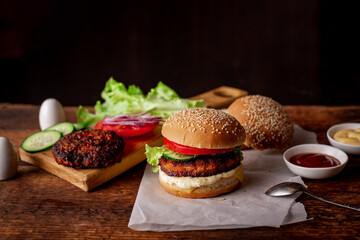 Home cooking hamburger or cheeseburger. Different ingredients for a classic hamburger. Wooden background. Food concept.