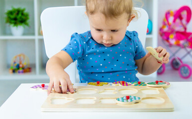 The child learns numbers at the table. Selective focus.