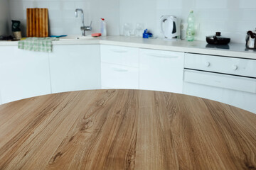 wooden table on the background of a white modern kitchen, a place for food, goods.