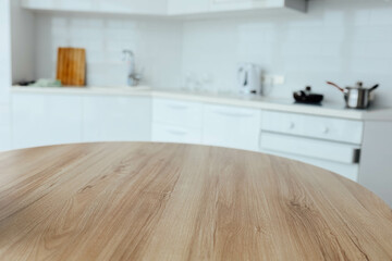 wooden table on the background of a white modern kitchen, a place for food, goods.