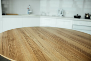 wooden table on the background of a white modern kitchen, a place for food, goods.