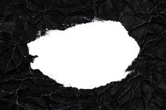 Ripped crumpled black paper with space