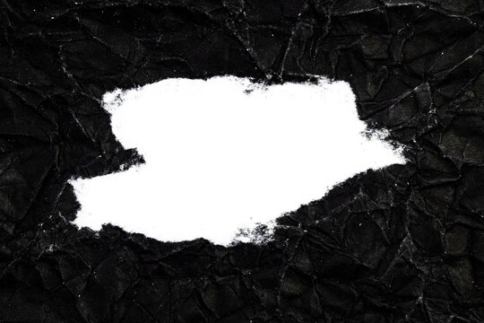 Ripped crumpled black paper with space