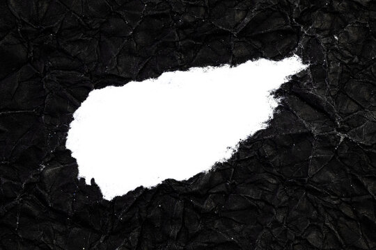 Ripped crumpled black paper with space