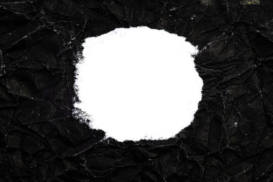 Ripped crumpled black paper with space