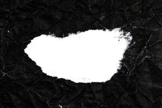Ripped crumpled black paper with space