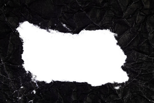 Ripped crumpled black paper with space