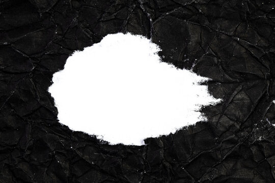 Ripped crumpled black paper with space