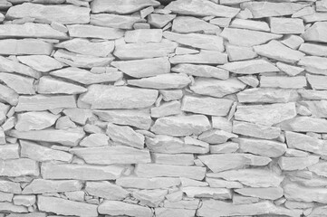 White grey stone wall texture in natural pattern for background and design art work.