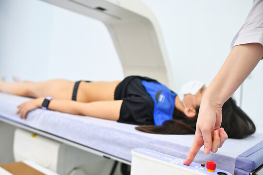 young pretty girl on examination in a modern clinic by densitometry