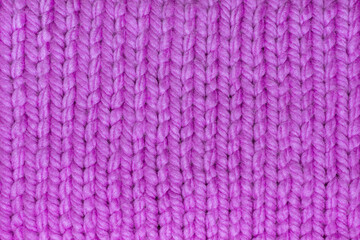 Fototapeta na wymiar Purple wool fabric created on knitting needles, 