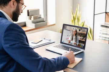 Fototapeta na wymiar Arabian businessman boss CEO freelancer student e-learning, having videocall conference conversation meeting online on laptop with colleague teacher tutor showing charts remotely on distance