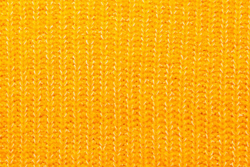 Knitted from threads on knitting needles cozy warm sweater, beautiful yellow color.