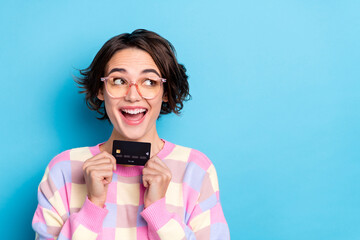 Photo of cool millennial brunette lady hold card look promo wear eyewear plaid pullover isolated on blue background