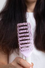 Comb with lost hair. Tangled and falling out hair, care for long hair concept