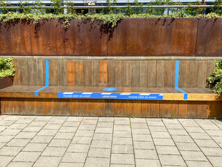 A bench in the area of Leeds known as The Leeds Dock, the bench has stickers on it reminding people...
