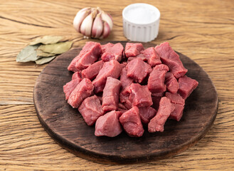 Chopped topside meat over wooden board with seasonings