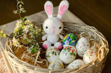Easter decoration : white toy bunny in an egg basket. Concept Easter - spring mood