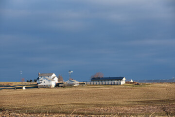 Amish Farm Homestead with Windmill on a Hill Underneath a Cloudy Blue Sky | Amish Country, Ohio