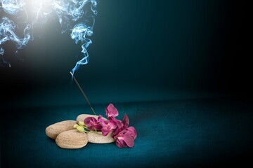 sacred incense stick on a background with a fire and a lot of smoke. The concept of incense, healing, meditation, relaxation, tranquility, calming.