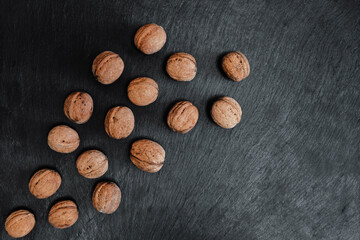 Lots of walnuts, like a flock of birds. 
On a black background