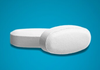 COVID-19 experimental antiviral drug, two white pills on a background
