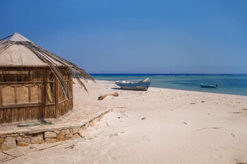 old wooden fishing boats resting on the beach of the bay blue lagoon in egypt