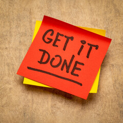 get it done advice or reminder handwriting on a sticky note, business, productivity and personal development concept