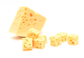Appetizing square slices of cheese with holes on a white background