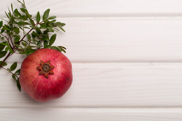 Fresh juicy pomegranate on white wooden background, top view