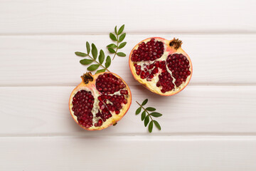 Fresh juicy pomegranate on white wooden background, top view
