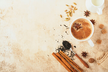 Masala tea. Masala chai spiced tea with milk and spices on light warm beige background. Traditional...