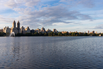 Fototapeta na wymiar Central Park Reservoir and the Upper West Side Skyline in New York City with a Fountain