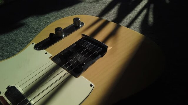 Medium close up panning across a custom classic honey blonde Fender Telecaster guitar