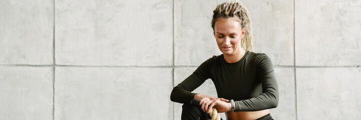 Young woman with prosthesis using battle ropes while working out