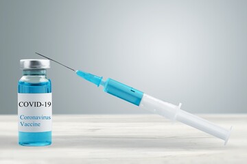 Small vaccine bottle for Coronavirus Vaccine injection with a medical syringe.
