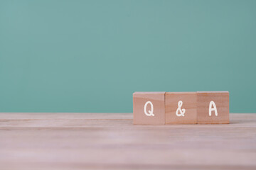 Q&A or "Q and A" with wooden blocks with letters, questions and answers customer service and support  concept , Copy space.
