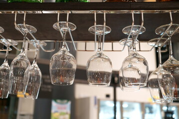 Fototapeta na wymiar Wine glasses hanging from a glass holder.