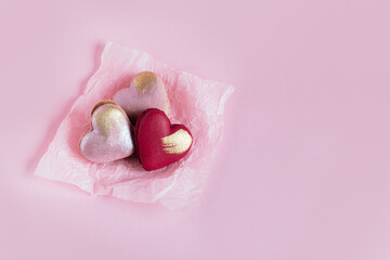 Heart-shaped macaroons on a pink pastel background. Concept for Valentine's Day.