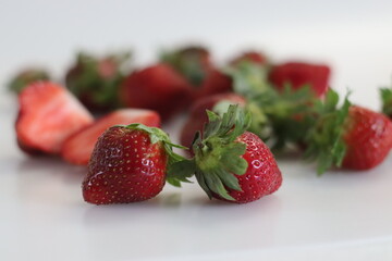 Fresh strawberries. Small and big. Pink red and green combination