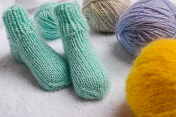 Fototapeta na wymiar Small handmade baby socks made of soft and high quality cotton yarn