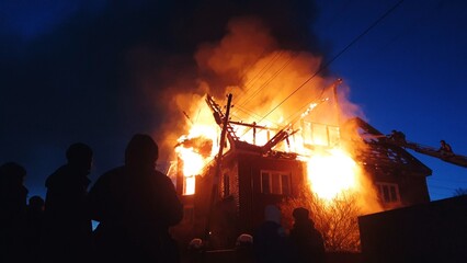 The roof of the house is on fire. The residential building burn, village. Firefighters put out a...