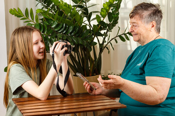 Senior cheerful woman holding smartphone having videocall online talk, communication with falovers, older generation modern tech usage concept