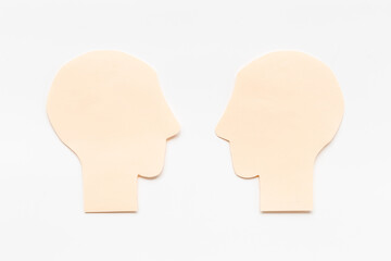 Social communication and connection concept with two paper human heads