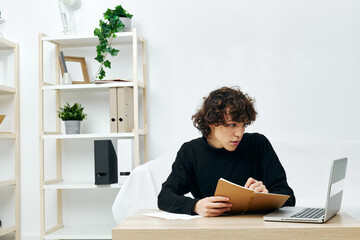 man sitting at the table in a black sweater lessons Lifestyle technology