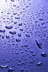Abstract blue water drops on dark  surface