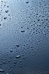 Abstract blue water drops on dark  surface