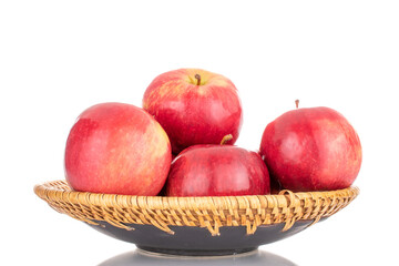 Several ripe red apples with a ceramic dish, macro, isolated on a white background.